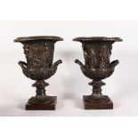 A GOOD PAIR OF BRONZE URNS, of campagna form, decorated with classical figures in relief. 12ins