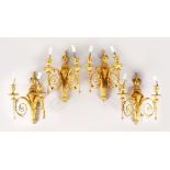 A VERY GOOD SET OF FOUR LOUIS XVI TWO-LIGHT WALL SCONCES with rams masks, urn finials and