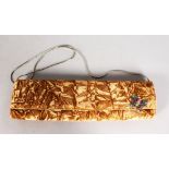 AN EMANUEL UNGARO BOXED GOLD VELVET EVENING BAG.