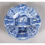 A DUTCH BLUE AND WHITE LOBED CIRCULAR DISH with Chinese dragon. 12ins diameter.