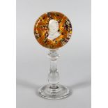 A MILLEFIORI CIRCULAR PEDESTAL PAPERWEIGHT inset with a portrait on a plain turned stem and base.