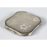 A FRENCH SQUARE ENGRAVED ENGINE TURNED COMPACT engraved with flowers. 3ins x 2.75ins.