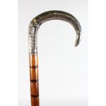 A WALKING STICK with carved SILVER HANDLE.