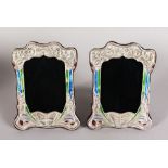 A PAIR OF ART NOUVEAU STYLE SILVER AND ENAMEL PHOTOGRAPH FRAMES. 8ins high x 6.5ins wide.