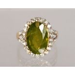 AN 18CT YELLOW GOLD, PERIDOT AND DIAMOND RING, 9CTS.