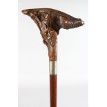 A WALKING STICK with carved wooden HEAD AND FISH handle.