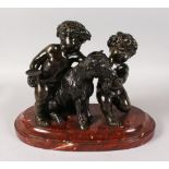 A SUPERB 19TH CENTURY FRENCH BRONZE. A GOAT BEING FED BY TWO CUPIDS, feeding him grapes, on a