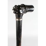 A WALKING STICK with carved HEAD HANDLE.