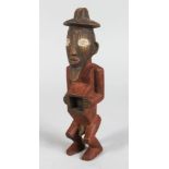 A CARVED TRIBAL FIGURE MAN with open chest. 9ins long.