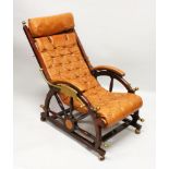 AN UNUSUAL SHIPS MAHOGANY AND BRASS RECLINING CHAIR with leather cushion.