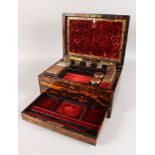 A VICTORIAN COROMANDEL VANITY BOX with inset brass carrying handles opening to reveal a velvet and