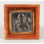 A SILVER ICON, MOTHER AND CHILD. 2.25ins x 2.5ins, in a leather frame.