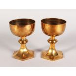 A GOOD PAIR OF GOTHIC STYLE BRASS CHALICES.