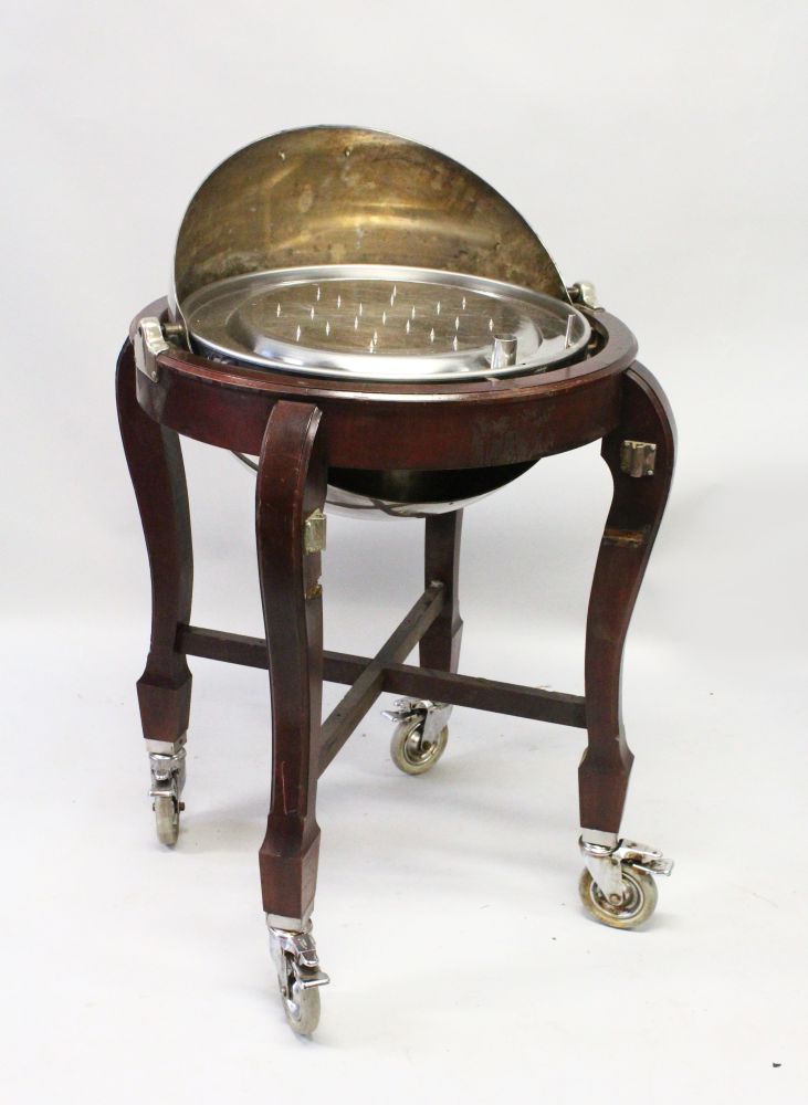 A MAHOGANY AND PLATED CARVERY TROLLEY, with folding dome shape cover, on four curving legs united by - Image 2 of 2