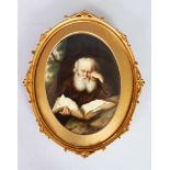 A GOOD CONTINENTAL OVAL PORCELAIN PANEL of an old bearded man reading a book. 7.25ins x 5.25ins,