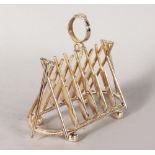 A PLATED TOAST RACK "CRICKET" of five pairs of bats, two wickets and ball. 7ins long.