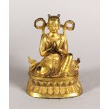 A GILT BRONZE FIGURE OF A SEATED EASTERN DEITY, on an oval base. 6.5ins high.