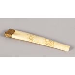 A CARVED IVORY PARASOL HANDLE.