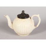 A STONEWARE GLOBULAR TEAPOT with pewter cover.