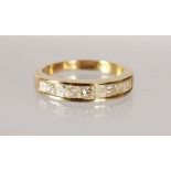 A 14CT YELLOW GOLD HALF ETERNITY RING, set with nine Princess cut diamonds.