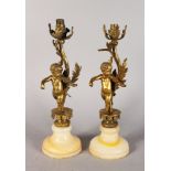 A PAIR OF LOUIS XVI DESIGN ORMOLU AND ONYX CUPID CANDLESTICKS, each playing musical instruments.