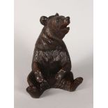 A BLACK FOREST BEAR TOBACCO BOX, with lift off head and glass eyes. 8ins high.