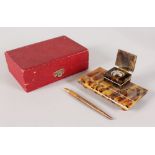 A TORTOISESHELL INKWELL and PEN, in original box. 4.5ins.