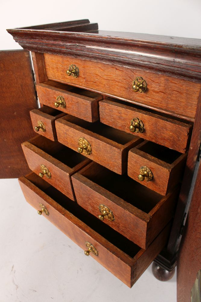 A GOOD 18TH CENTURY OAK APPRENTICES CUPBOARD, with a pair of double doors enclosing drawers, with - Image 3 of 4