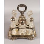 A GEORGE III EIGHT BOTTLE CRUET, with cast handle, anthemion mounts on four claw feet, complete with
