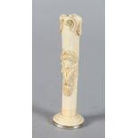 A CARVED IVORY PIPE TAMPER. 3.25ins long.