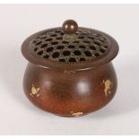 A SMALL CHINESE GOLD SPLASH CIRCULAR BRONZE CENSER AND COVER. 2.5ins diameter.