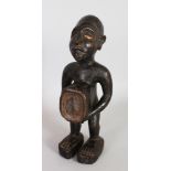 A CARVED WOOD TRIBAL FIGURE with glass frosted base. 12.5ins high.