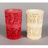 A PAIR OF RED & WHITE IVORY SHAKER CUPS. 3ins high.
