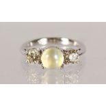 AN 18CT WHITE GOLD RING, set with a centre CHRYSOBERYL STONE FLANGE by TWO DIAMONDS.