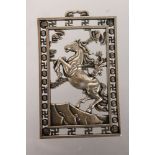 A CHINESE SILVER PIERCED "HORSE" PENDANT.