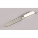 AN 18TH CENTURY CHELSEA KNIFE HANDLE with scroll moulded decoration, having silver ferrule, and
