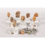 A SMALL COLLECTION OF EIGHT ROMAN STONE FIGURES on Perspex stands, three other pieces and a pipe.