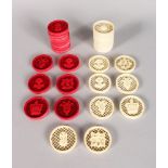 A SET OF RED & WHITE IVORY PIERCED AND CARVED DRAUGHT PIECES, sixteen white and fourteen red (30).