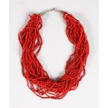 A RED CORAL MULTI STRAND NECKLACE.