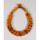 A STRING OF ART DECO AMBER BEADS.