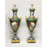 AN IMPOSING PAIR OF SEVRES STYLE PORCELAIN AND ORMOLU FLOOR VASES, each decorated with landscape