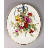 A LATE 19TH CENTURY DERBY PLAQUE of oval shaped painted with a large bunch of flowers tied with a