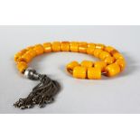 A SUPERB STRING OF AMBER BEADS with silver tassel. Weight 100gms.