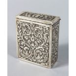 A SILVER BOX AND LID with repousse decoration. 2.75ins.