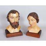 A PAIR OF 19TH CENTURY ITALIAN CARVED WOOD BUSTS OF A MAN AND WOMAN, on square bases. 9ins high.