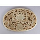 A CHINESE OVAL JADE-LIKE PLAQUE, pierced with birds and lotus, 4.5in x 3.1in at widest points.