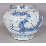 A CHINESE YUAN STYLE BLUE & WHITE PORCELAIN DRAGON JAR, the base unglazed, 12.9in wide at widest