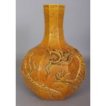 AN UNUSUAL MING STYLE OCHRE GLAZED MOULDED HEXAGONAL SECTION PORCELAIN DRAGON BOTTLE VASE, the