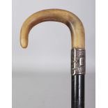 A HORN HANDLED WOOD WALKING STICK, with an unmarked embossed silver collar, the horn possibly