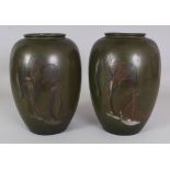 A PAIR OF EARLY 20TH CENTURY SIGNED JAPANESE GREEN GROUND MIXED METAL & INLAID VASES, the side of
